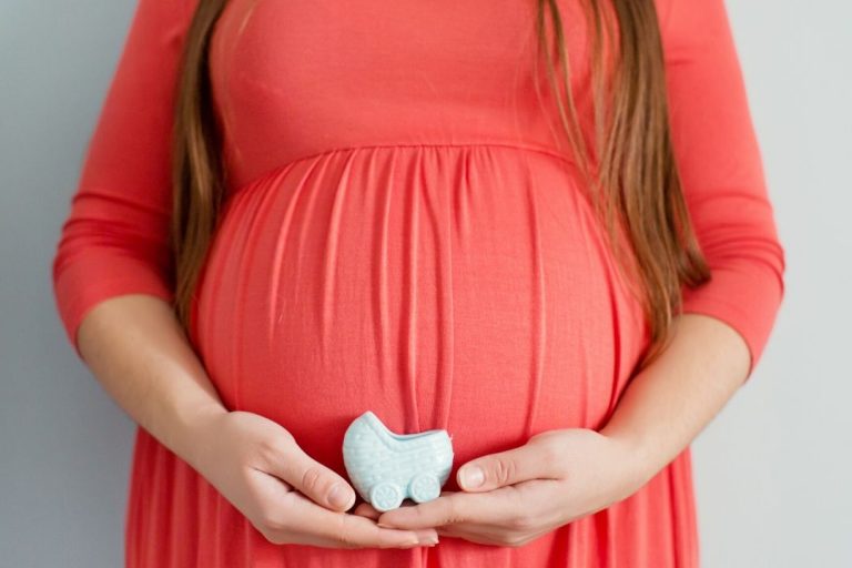 plus size and pregnant woman wearing an orange dress