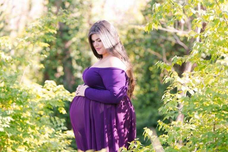 Plus Size Pregnancy With Twins woman wearing plus size purple gown