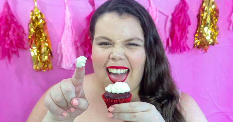 Plus size woman eating a cupcake