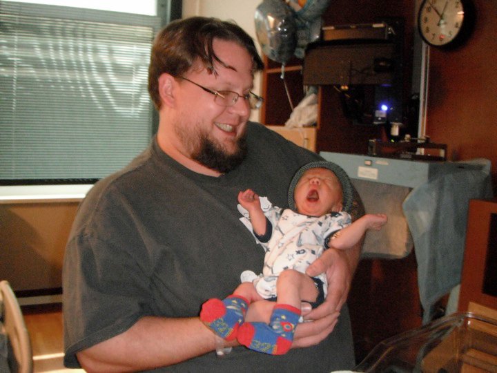 Dad holding newborn 