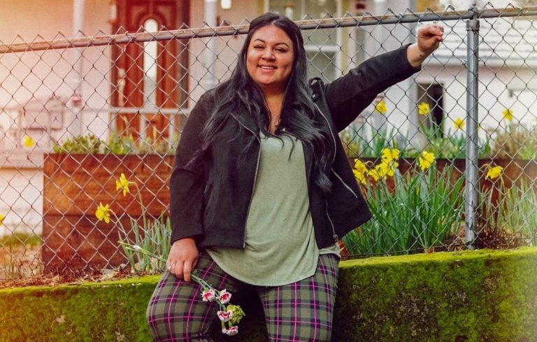 plus size woman standing outside smiling