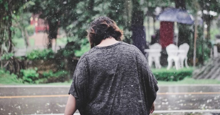 plus size woman walking in the rain