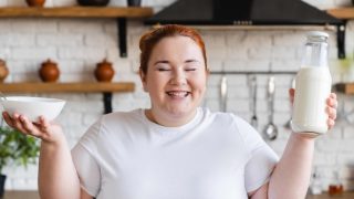 plus size woman smiling with food