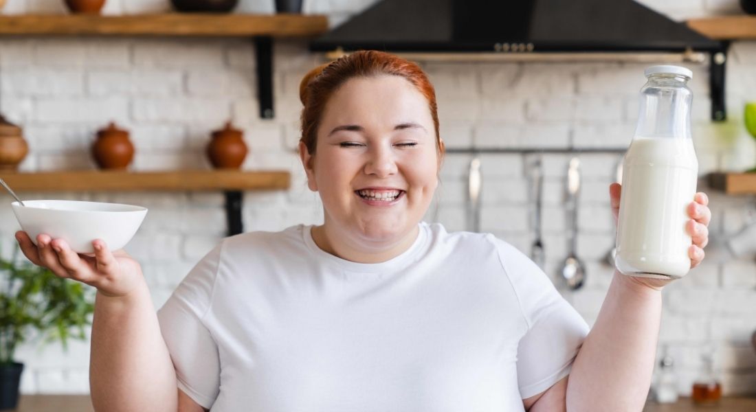 plus size woman smiling with food