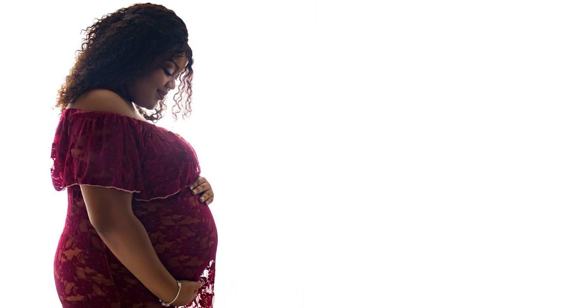 plus size woman in a red plus size maternity dress