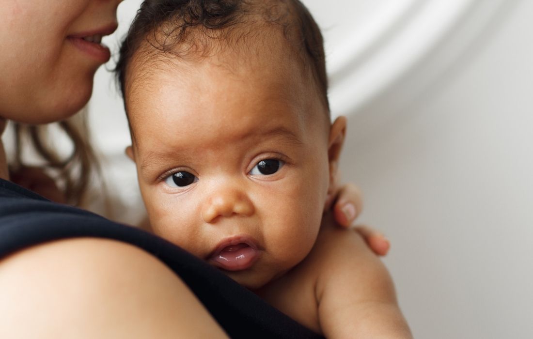 plus size breastfeeding woman with infant