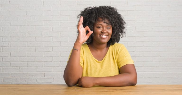 plus size woman holding up fingers to say okay for new year same you