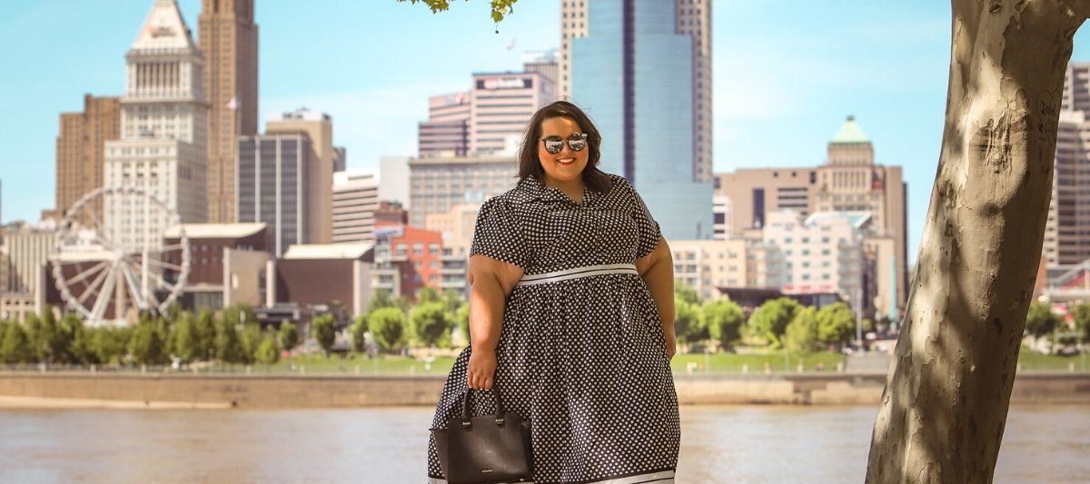 plus size woman standing by a river