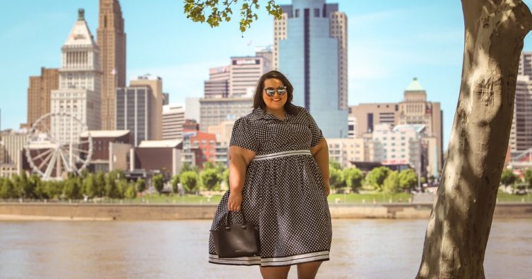 plus size woman standing by a river