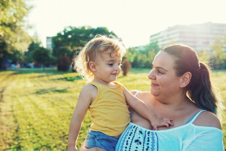 plus size mom and daughter in a park