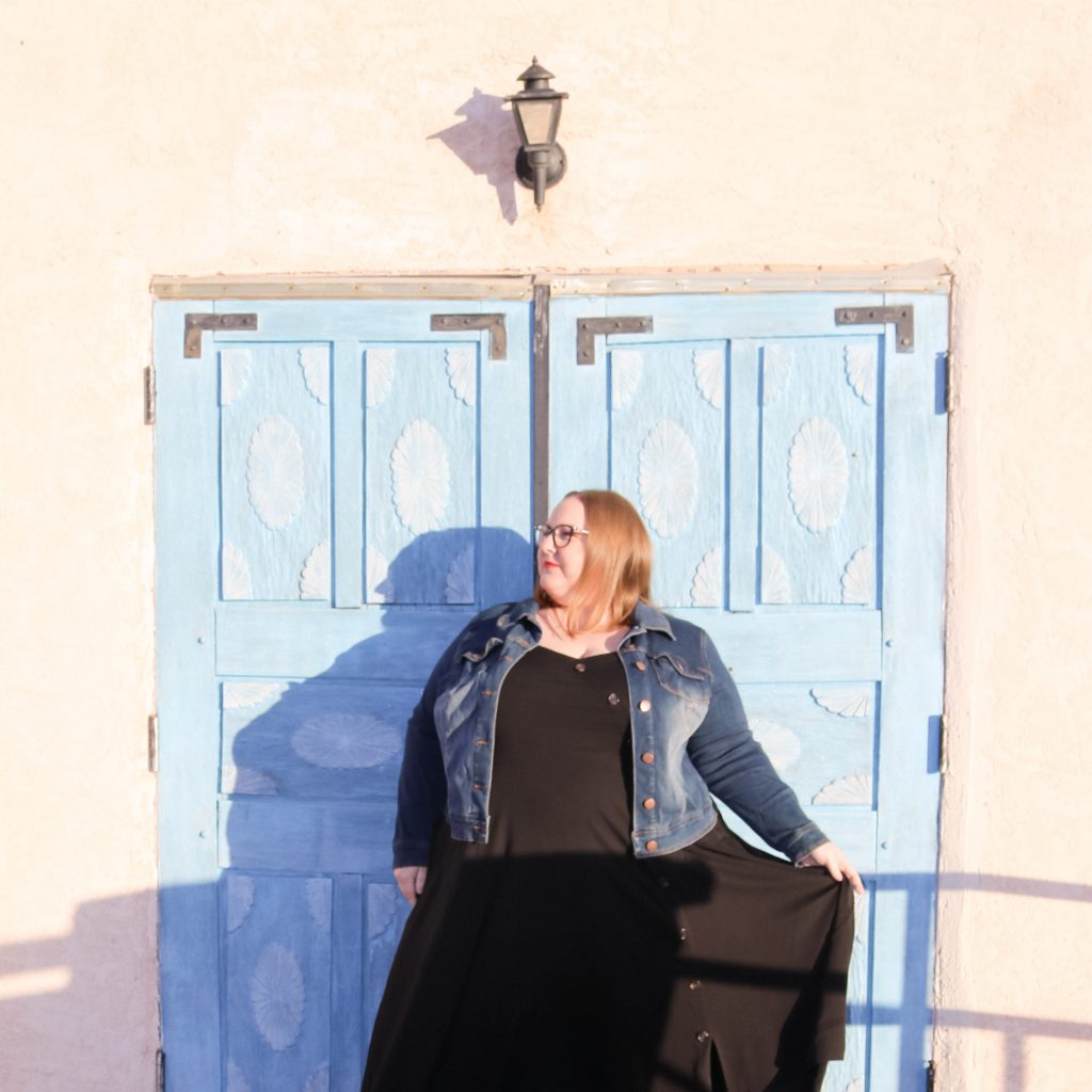 Jen McLellan standing in front of a blue door 