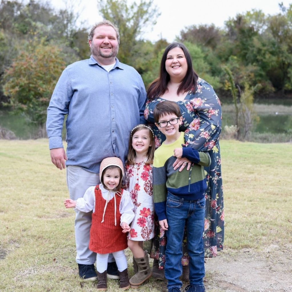 family of five smiling 