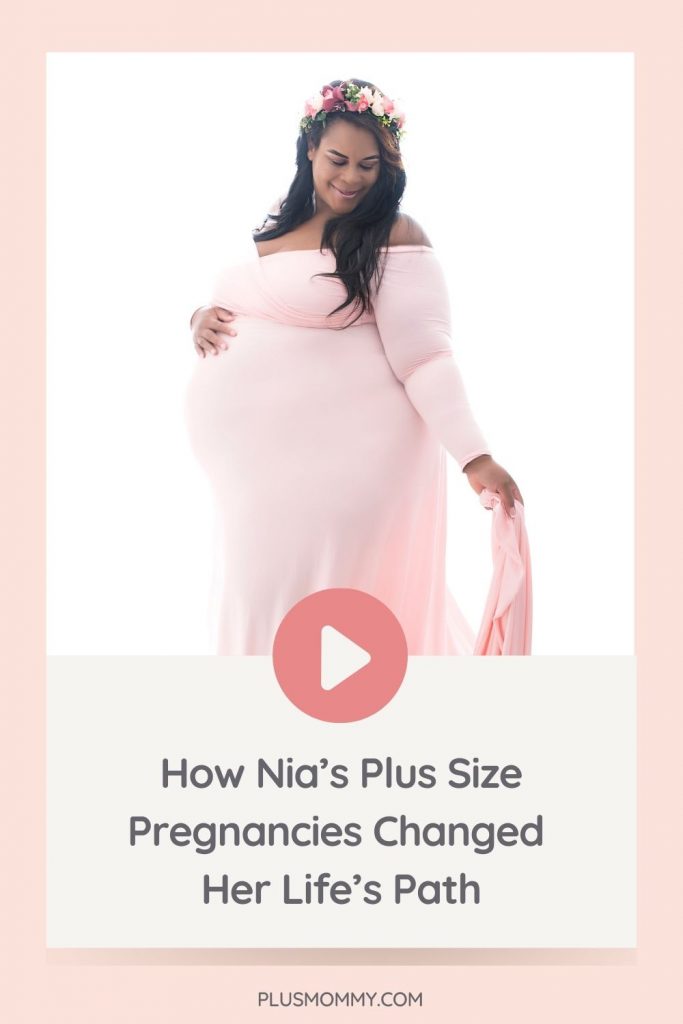 plus size pregnant woman wearing a pink plus size maternity gown