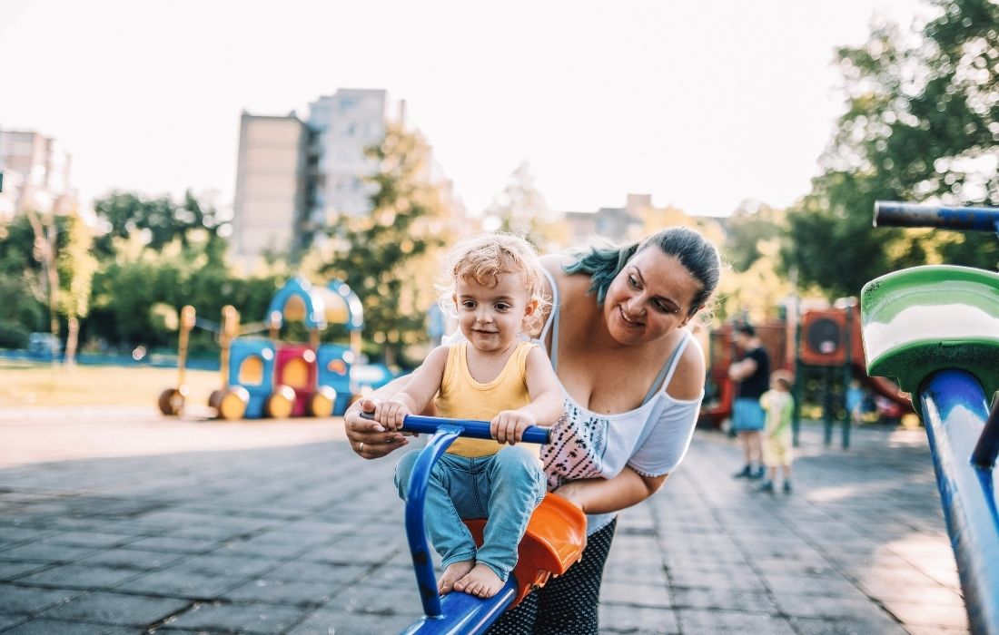 Plus Size Mom playing with son on playground