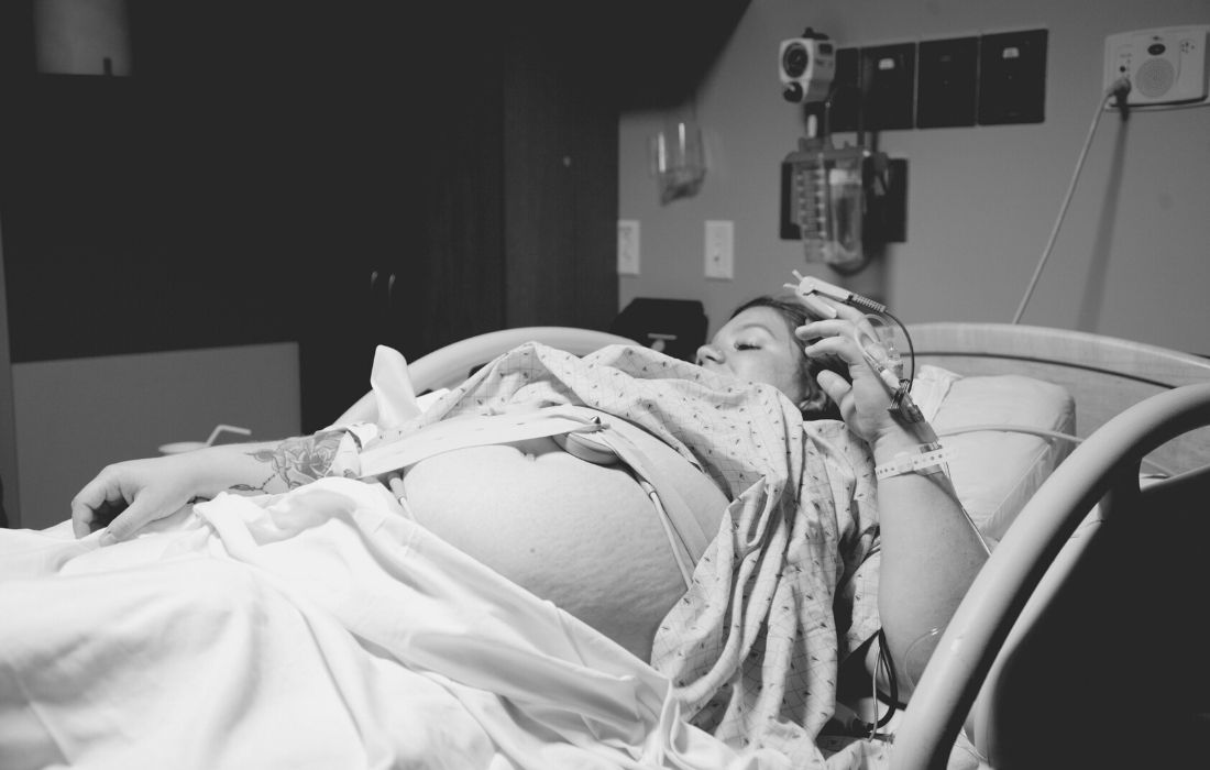 plus size woman in hospital bed experiencing Weight Stigma During Pregnancy