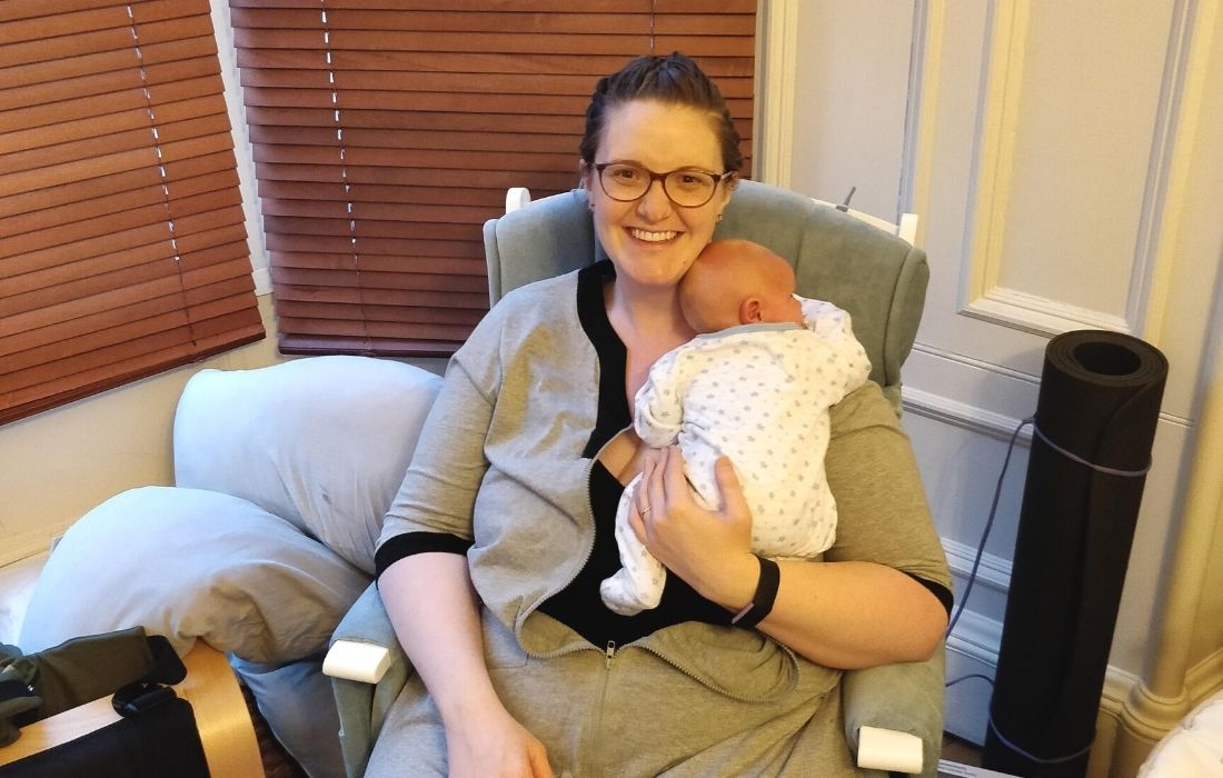 Elizabeth Giving Birth As A Plus Size Woman In Scotland holding newborn