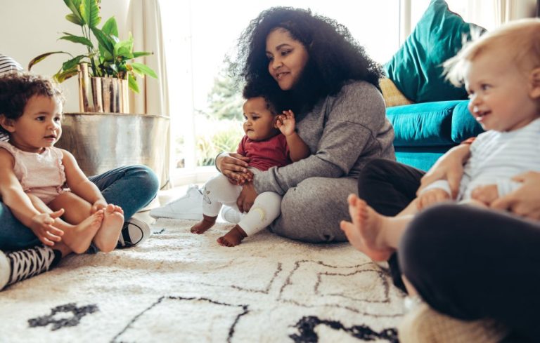 How To Make Mom Friends with a mom sitting on the floor with friends