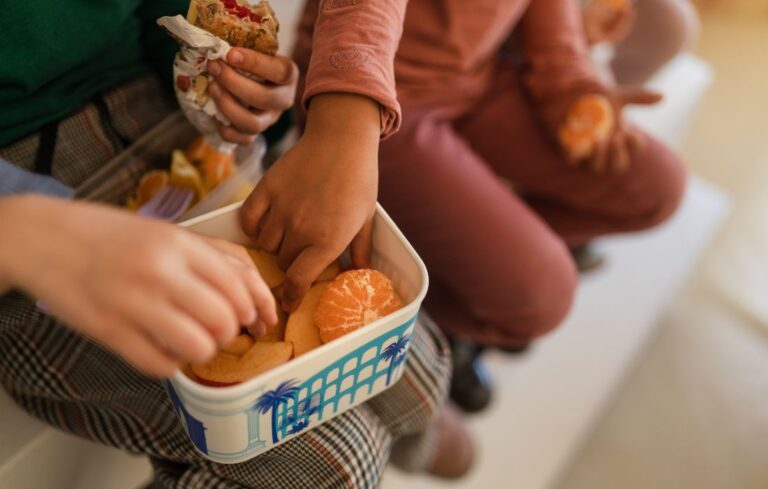 kids eating fruit out of a box