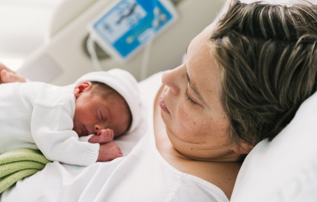 person in a larger body with baby on their chest following a labor induction