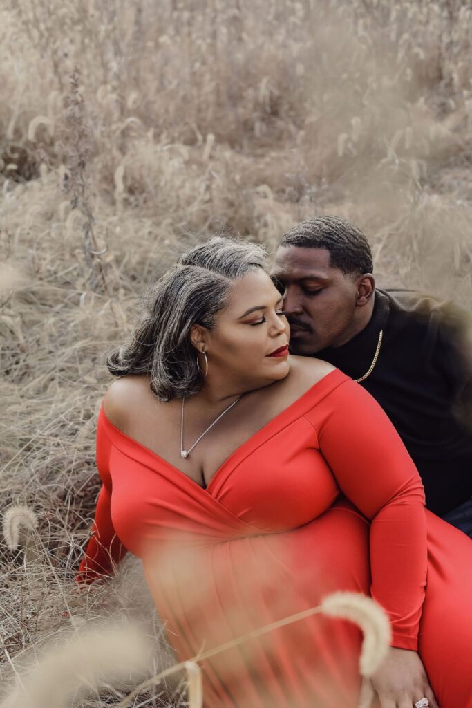 couple plus size maternity photo shoot of a woman and man