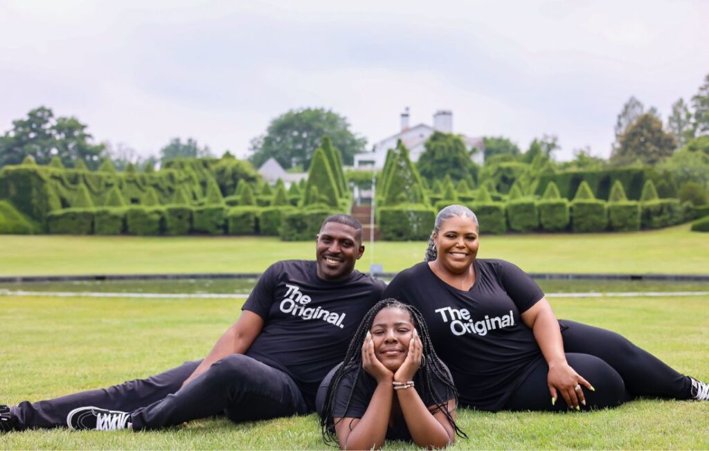 family of three maternity picture on the grass