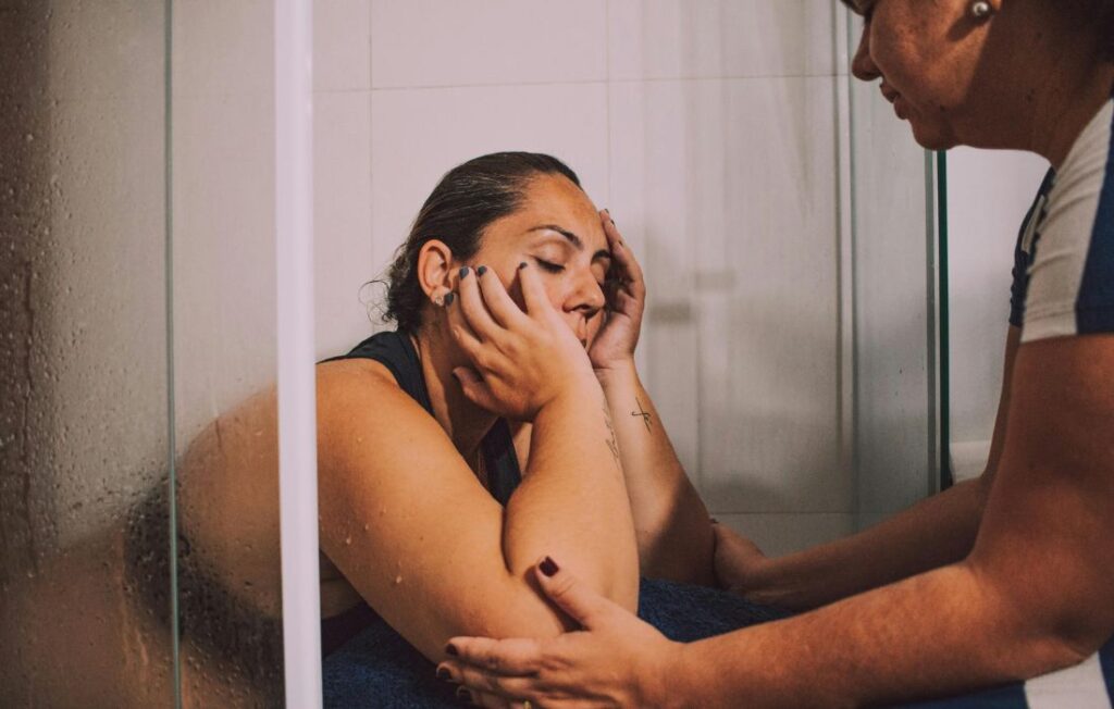 plus size woman in labor supported by a midwife