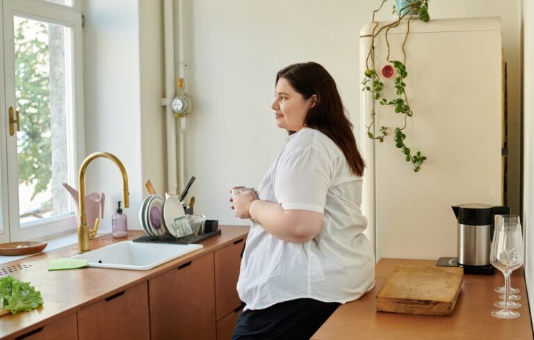 fat and pregnant woman holding a mug
